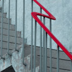 Concrete stairs with red banister